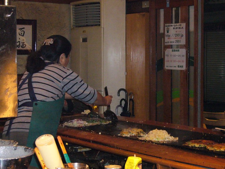 441 - Okonomiyaki being cooked for dinner in Osaka. This was my first visit to Osaka, and I was with my American co-worker, so we were just wandering around looking for stuff.