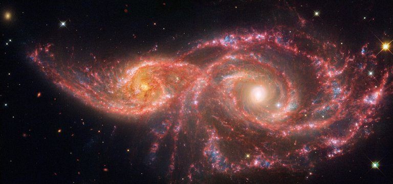 Hubble & Webb- Galaxies IC 2163 and NGC 2207. NASA, ESA, CSA, STScI, CC BY-SA IGO 3.0, CC BY-SA 3.0 IGO, via Wikimedia Commons.