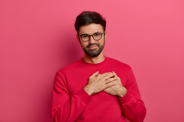 grateful-bearded-man-presses-palms-heart-being-moved-touched-by-pleasant-words-appreciates-received-gift-wears-spectacles-pink-jumper-expresses-gratitude-poses-against-pink-wall_273609-42815.jpg
