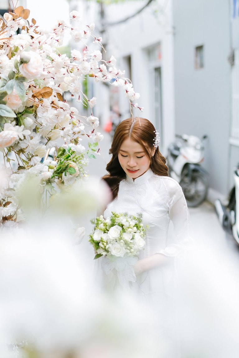 Bride in white Ao Dai. She is very beautiful