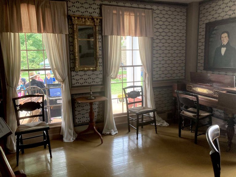 The sitting room of the inn had usually been used by the friends of the women of the family that owned the inn, according to the displayed information. The Farmers Museum in Cooperstown, New York makes history feel hospitable.