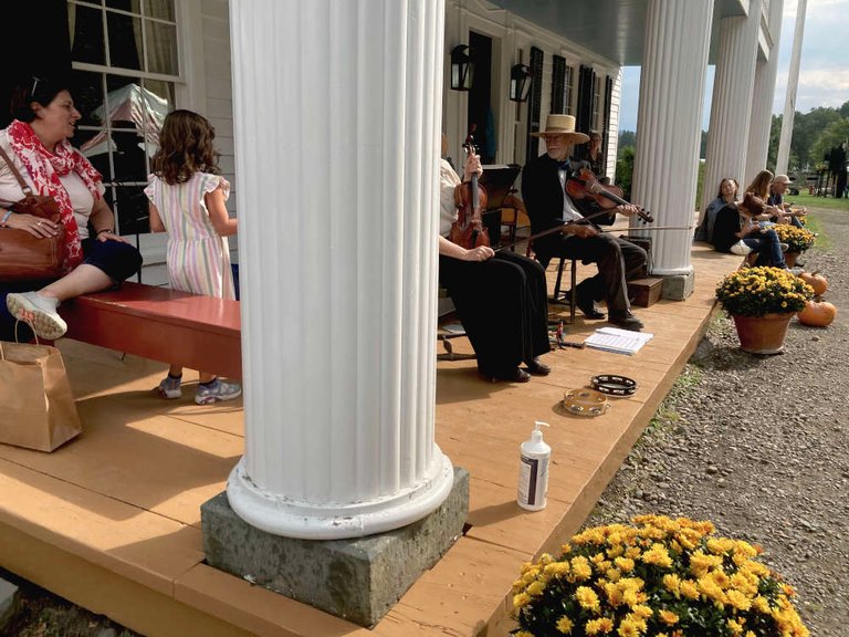 Reenactor musicians played fiddle music on the porch of the tavern, which was a Classical style building.