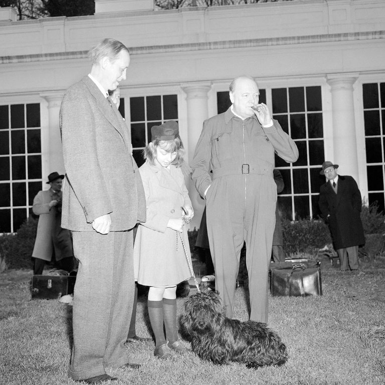 Winston Churchill, smoking a cigar, at the White House, wearing a wartime 'siren suit'. Pic: AP 