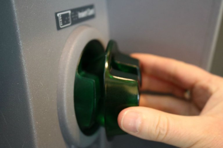 card skimmer being installed on the ATM card slot.jpg