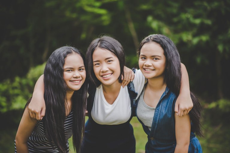 happy-teenage-friends-smiling-outdoors-park.jpg