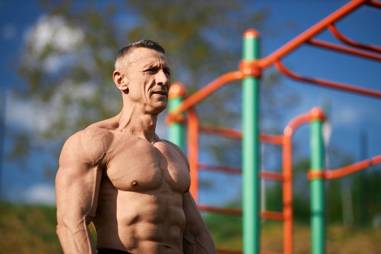 fitness-man-with-muscular-bare-torso-posing-sports-ground.jpg