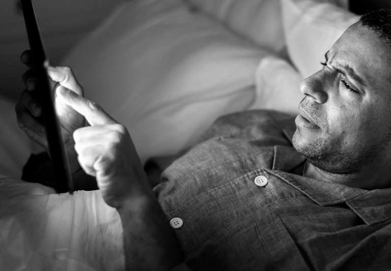 man-using-phone-on-bed.jpg