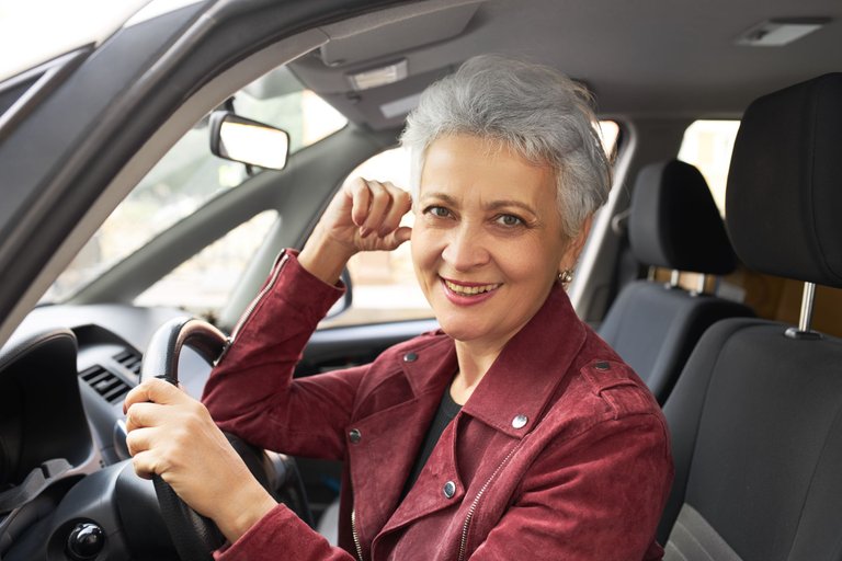 portrait-charming-happy-mature-female-with-short-gray-hair-sitting-driver-seat.jpg