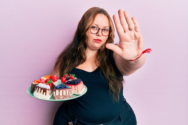 plus-size-caucasian-young-woman-holding-cake-slices-with-open-hand-doing-stop-sign-with-serious-confident-expression-defense-gesture.jpg