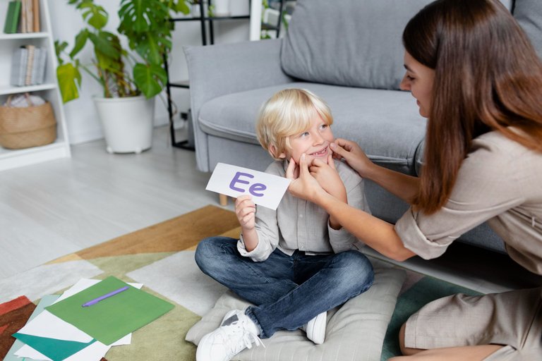 young-woman-doing-speech-therapy-with-little-blonde-boy.jpg