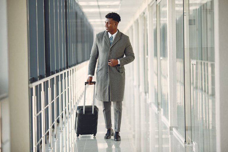 elegant-black-man-airport-with-suitcase.jpg
