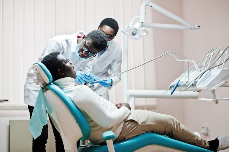 african-american-man-patient-dental-chair-dentist-office-doctor-practice-concept-professional-dentist-helping-his-patient-dentistry-medical-drilling-patient-s-teeth-clinic_627829-13721.jpg