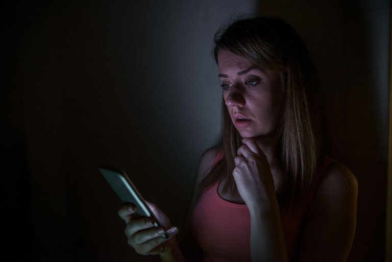 sad-news-upset-young-woman-with-mobile-phone-reads-message-night-portrait-home.jpg