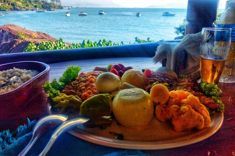 Fish Shrimp sauce with sea view in the background. Beer welcome