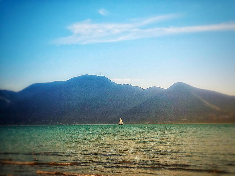 Sailing boat with the continent at background