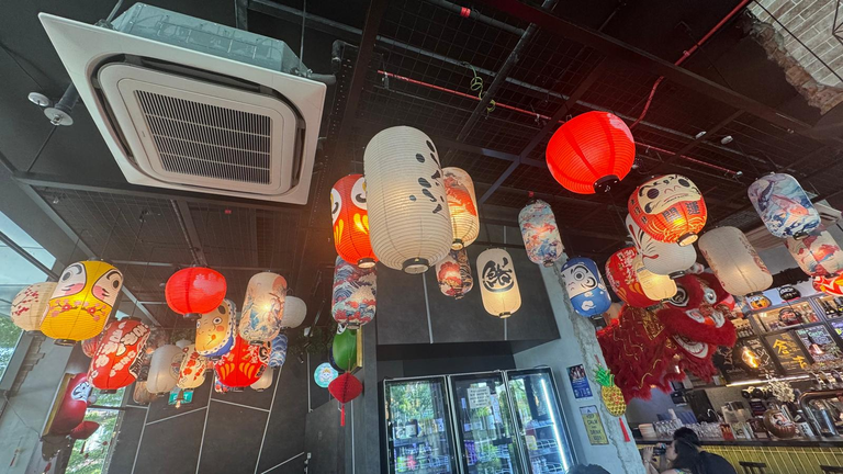 Loads of Japan Doll Lantern fill the ceiling of the restaurant with a fridge filled with various interesting beer