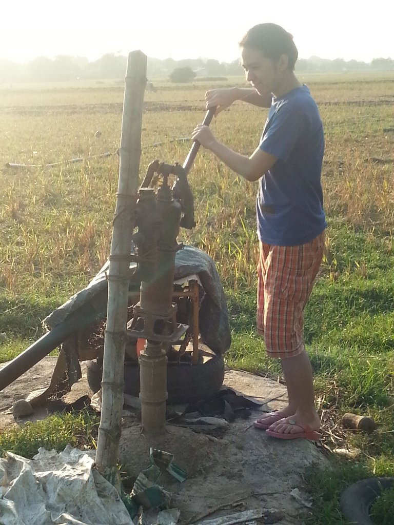 9. Sis pumping water.jpg