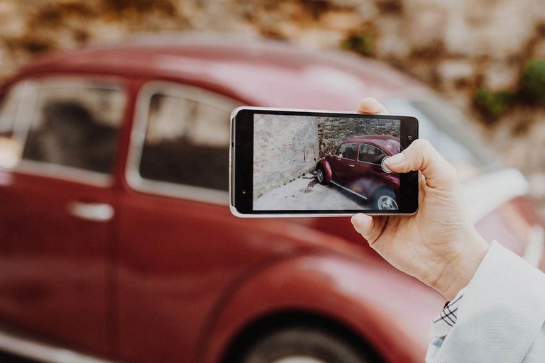 girl-taking-photo-of-retro-car-with-smartphone--2549917934.jpeg