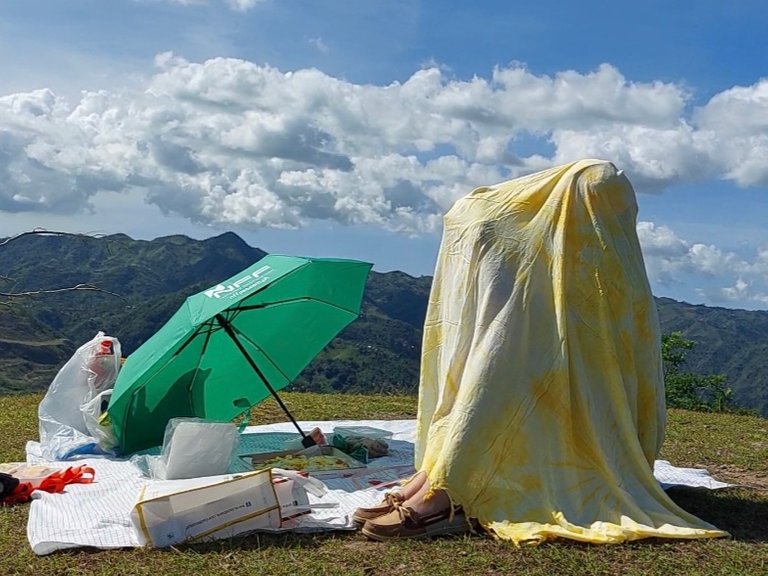 Trying to hide away from the sun with a blanket and an umbrella, lol!