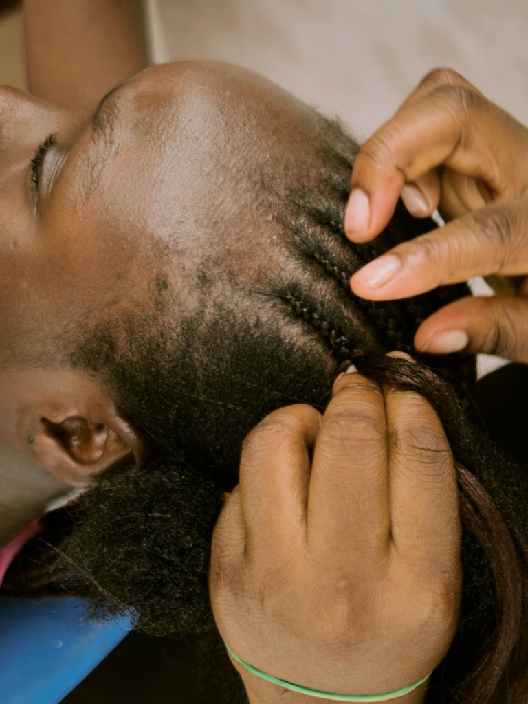 free-photo-of-a-young-woman-having-her-hair-braided.jpeg