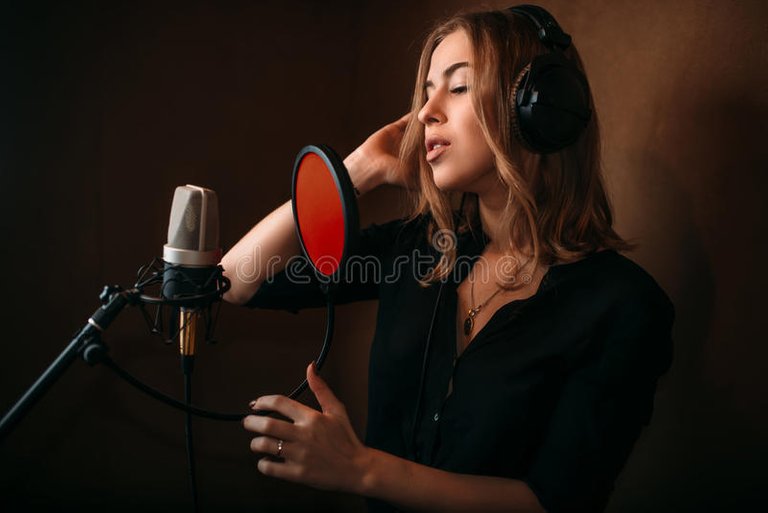 female-singer-recording-song-music-studio-woman-vocalist-headphones-against-microphone-audio-professional-90159437.jpg