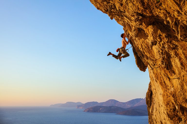 rockclimberjumpingonhandholdswhileclimbingPG3QLUX.jpg