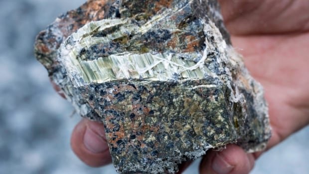 A chunk of asbestos in its natural form is shown at the now closed Jeffrey mine earlier this year in Asbestos, Que. The federal government, which has already banned the export of the material, which is known to cause deadly cancers and lung diseases, is set to announce a ban on imports next week