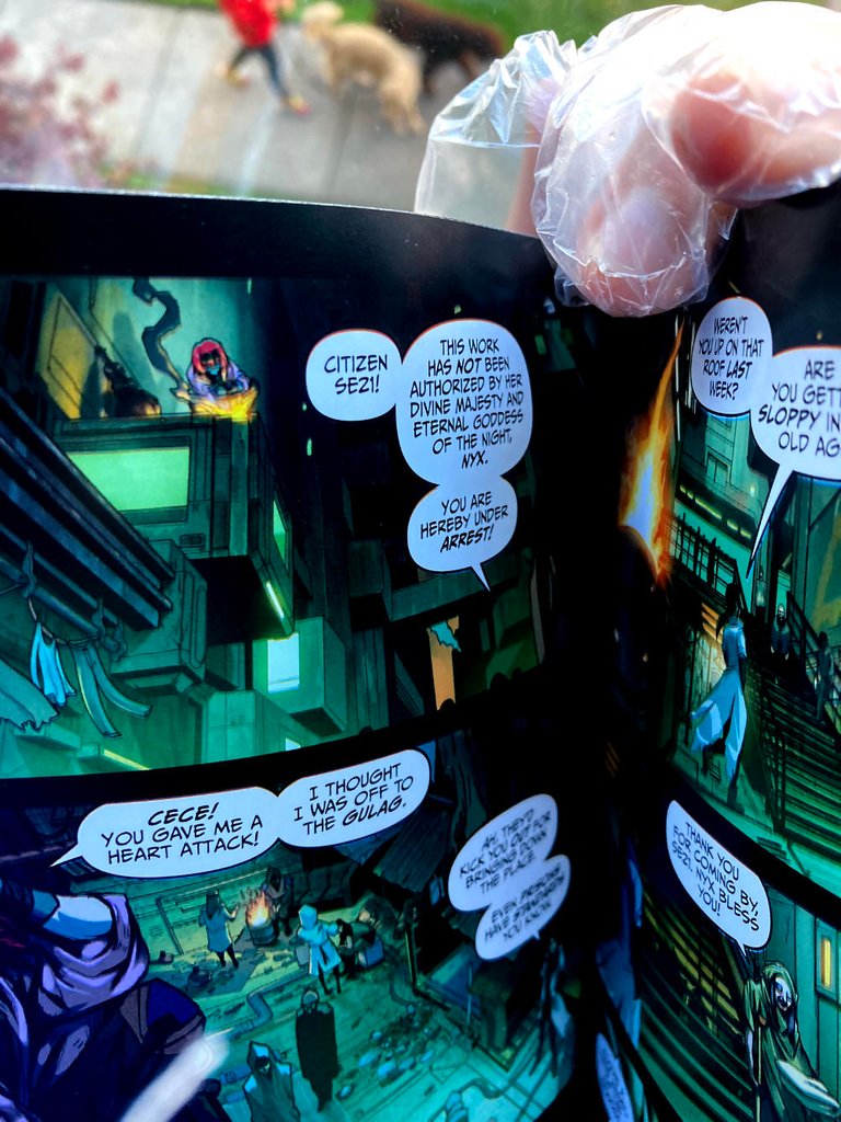 Photo of a gloved hand holding open the Artemis graphic novel