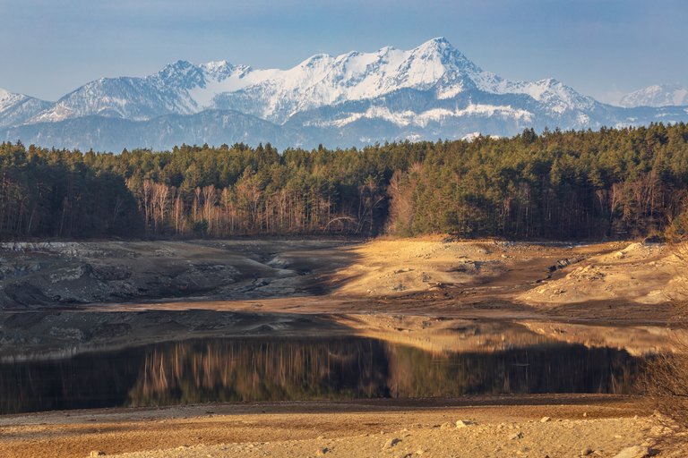 Lake Forstsee (dry), Karawanks Mountain Range and Mittagskogel Mountain