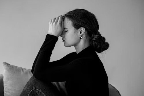 [Source] (https://unsplash.com/photos/a-black-and-white-photo-of-a-woman-sitting-on-a-couch-KI_TGfdSC5o)