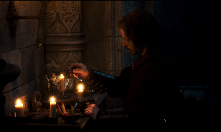 Screenshot of The Wheel of Time Episode 5: Blood Calls Blood, depicting a warder charater engaging in a religious pratice at a small alter using candles, figurines, and incense