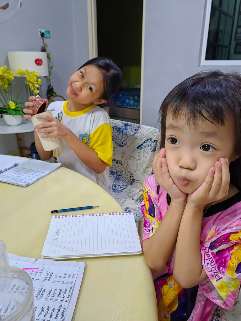 Before doing homework, smiling sweetly for mom to take pictures first.