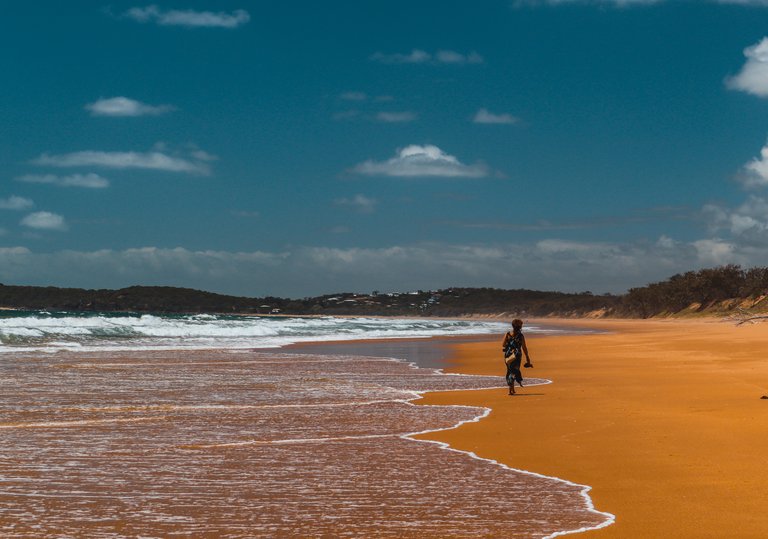 lonely_woman_walking_on_the_beach.jpg