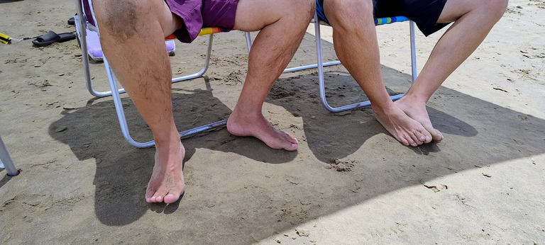 My friends taking shelter from the sun under a tent, sitting in chairs. This is the photo for the Shadow Hunters SMASh Contest-Round 359