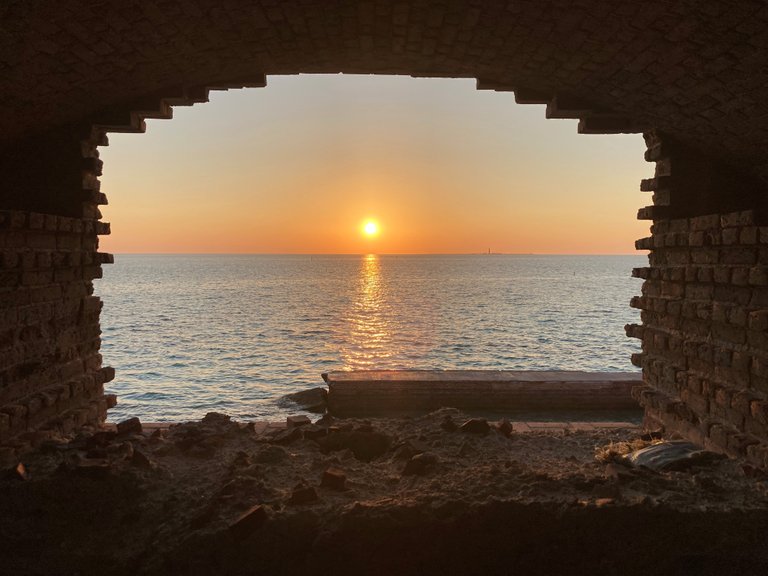 Sunset through fort archway
