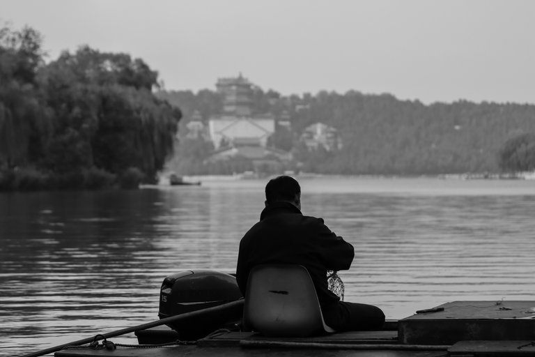 man_sitting_on_a_platform_fishing_in_a_lake_2_1.jpg