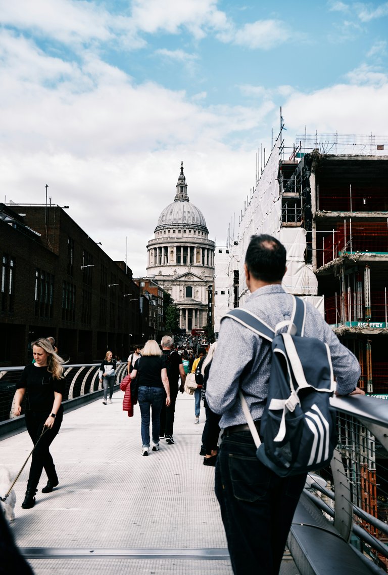 (Source)[https://unsplash.com/photos/a-group-of-people-walking-on-a-bridge-4LQpPEOSFDg]