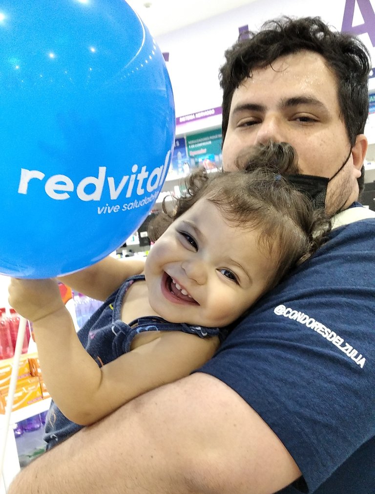 When we Got to the pharmacy to buy the medicines, she was deeply happy with her balloon