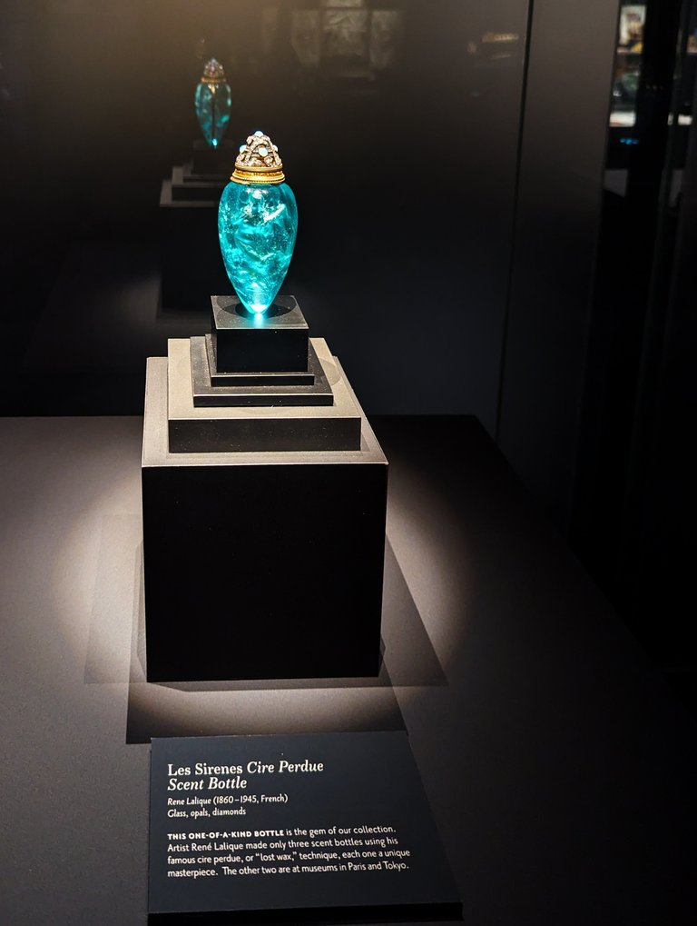 Les Sirenes Cire Perdue Scent Bottle," created by the artist Rene Lalique with the materials, "Glass, opals, diamonds,