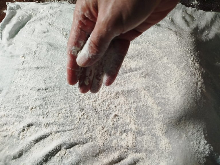 Generously sprinkling flour