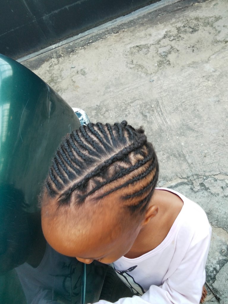 Braiding my daughter's hair for school.