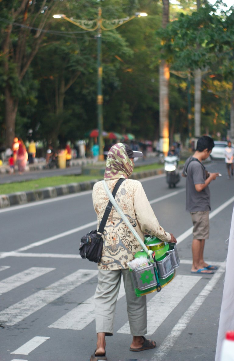 [Source](https://unsplash.com/photos/a-person-carrying-a-bag-walking-across-a-crosswalk-K4s46oMAiJ4)