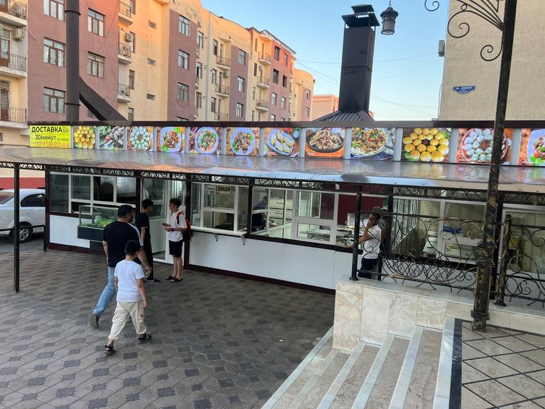 Outdoor section of the restaurant with mangals sizzling and photo displays of delicious dishes you can order.