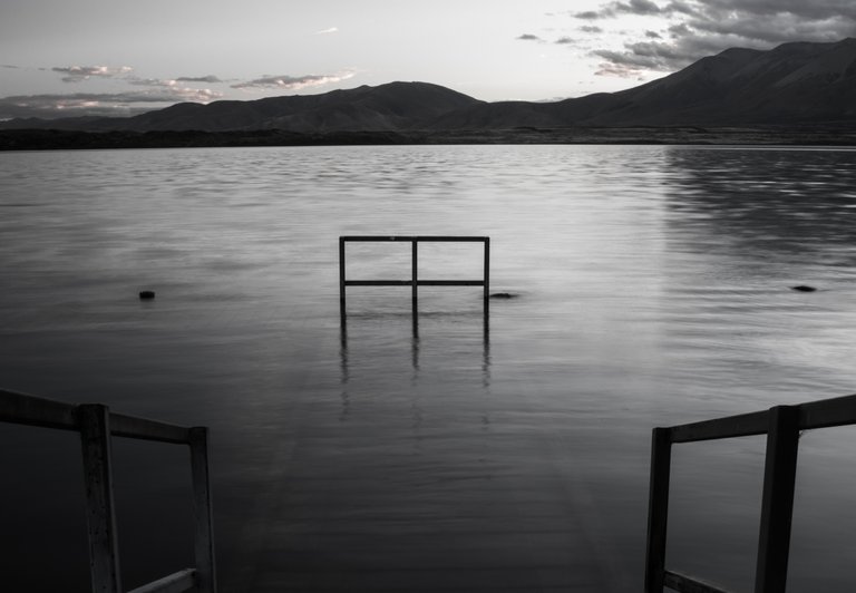 black_and_white_shot_of_a_quiet_and_empty_dock_on_perfect_symmetry_3.jpg