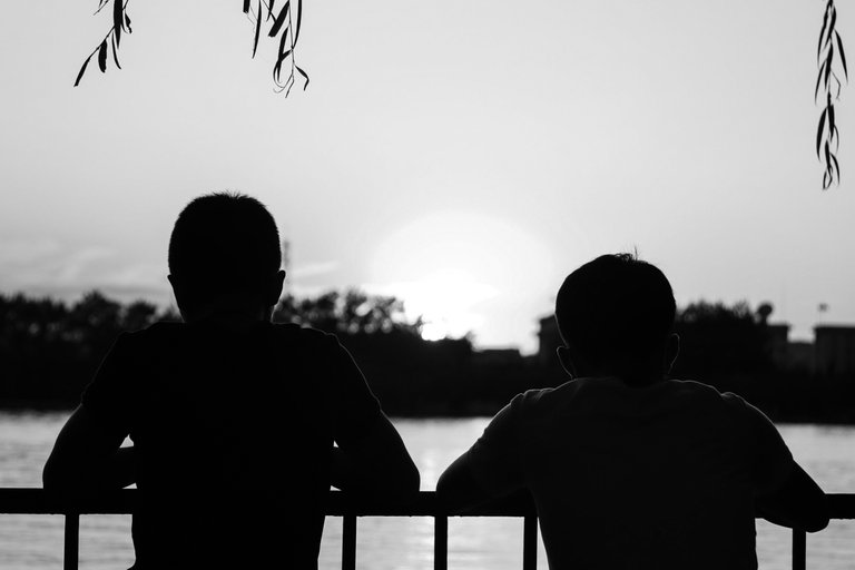 silhouette_of_two_young_kids_against_the_sunset_1.jpg