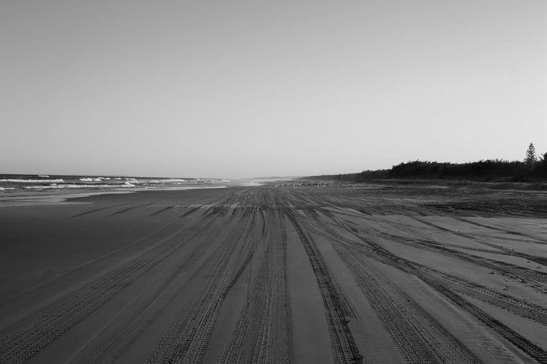 solitary_road_on_the_beach_with_the_tyre_prints_on_the_sand.jpg