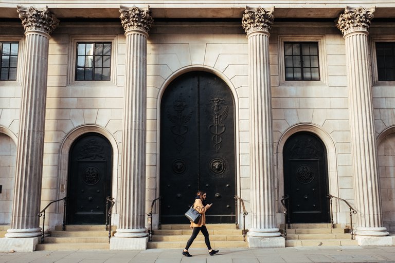 woman_walking_past_bank.jpeg