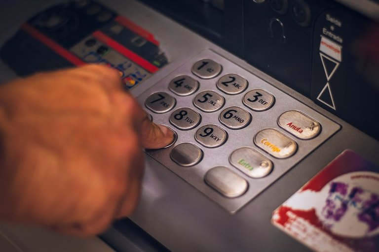 Hand-punching-an-atm-machine.jpg