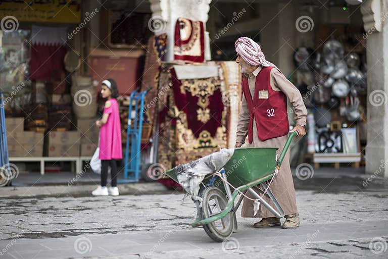 doha-qatar-may-wheel-barrow-worker-market-souq-waqif-workers-used-to-load-goods-old-traditional-times-wheel-212914577.jpg