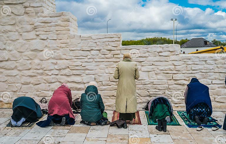 muslim-women-pray-namaz-praying-prayer-mats-against-old-stone-wall-248650186.jpg